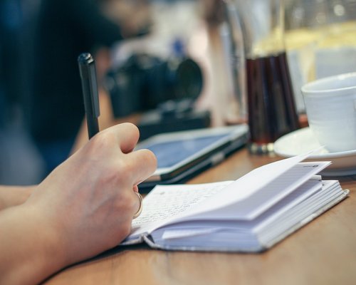 A person taking a short stretching break from their office desk