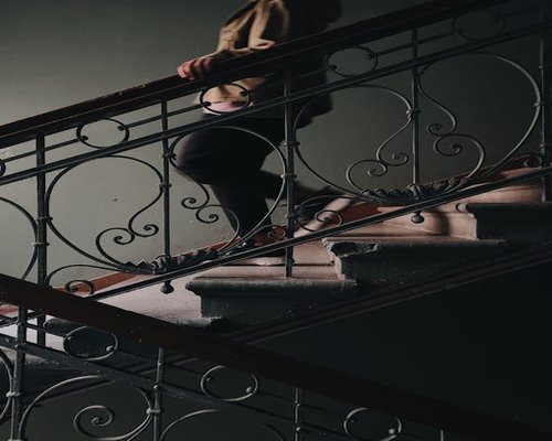 A person walking up the stairs confidently in an apartment complex